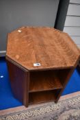 An early 20th Century oak occasional table with bookshelf under