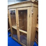 A rustic pine glazed cabinet , width approx. 130cm, height 180cm