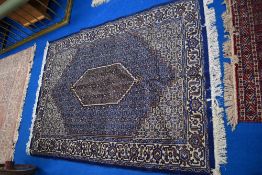 A machine loomed Sennah design rug with central lozenge enclosed by foliate motif filled ground,
