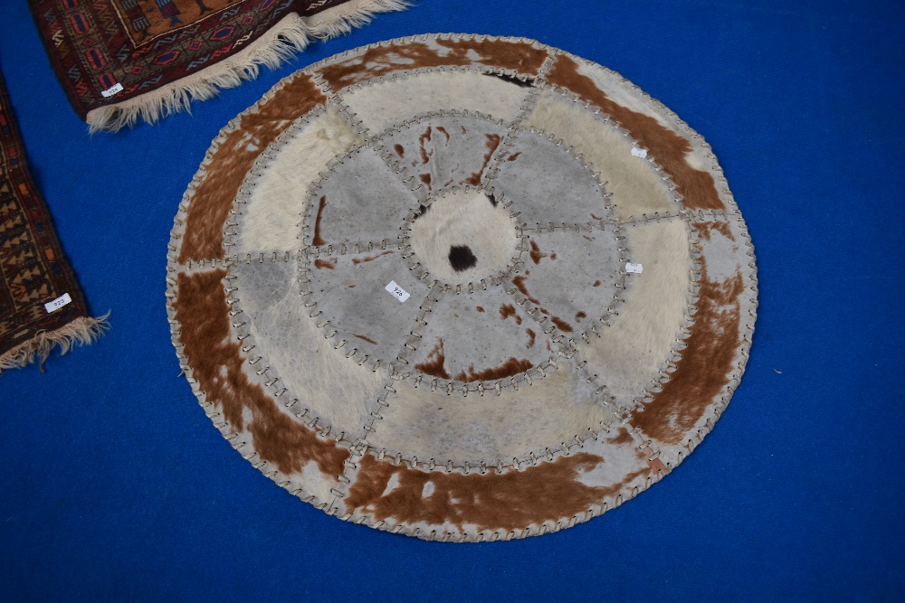 A circular animal hide throw.