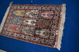 A Persian prayer rug of typical desgin, approx 107 x 62cm