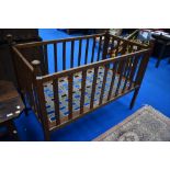 An early 20th Century oak Arts and Crafts cot, believed to be Liberty, bearing label W & S patent,