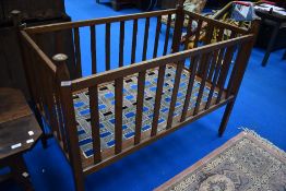 An early 20th Century oak Arts and Crafts cot, believed to be Liberty, bearing label W & S patent,
