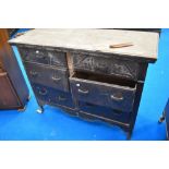 An antique chest of six large drawers with carved fronts