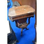 A late Victorian or Edwardian mahogany sewing table having inlaid decoration