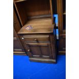 A modern Ercol mid stain narrow shelf with cupboard under