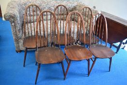 A set of six Ercol high hoop and stick back kitchen chairs in dark stain with H stretchers