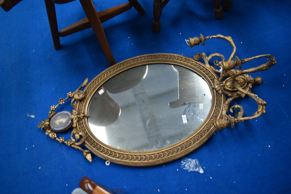 An Adams style wall mirror with three branch candle holders