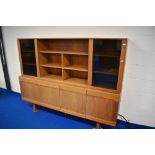 A vintage teak sideboard with part glazed top section