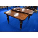 A Victorian mahogany wind out dining table on fluted legs