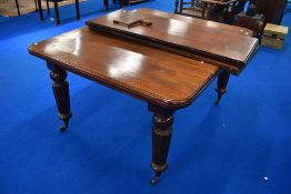 A Victorian mahogany wind out dining table on fluted legs