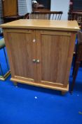 A modern light oak TV cabinet/desk unit, approx dimensions W69cm D52cm H85cm