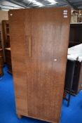 An Art Deco single wardrobe with an oak case.