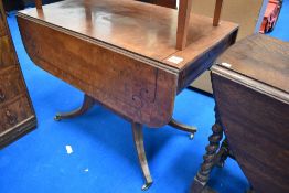 A Victorian tea table in an Aesthetic style with drop leaf and under drawers