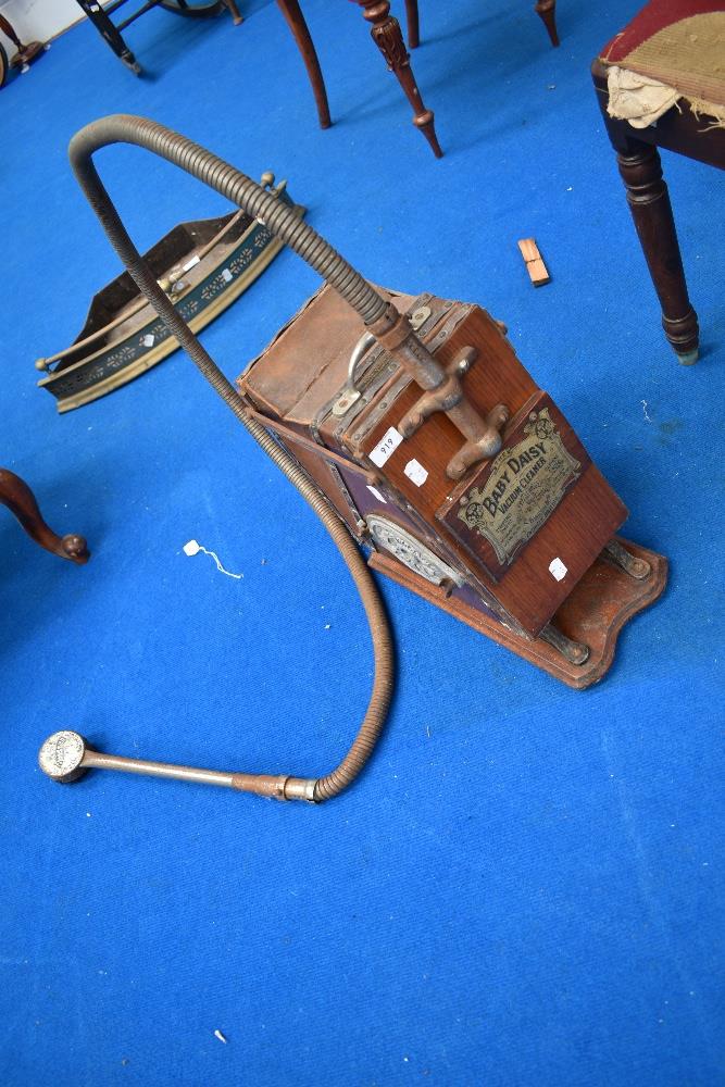 An antique vaccuum cleaner 'Baby Daisy' vacuum cleaner