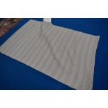 A modern rug, by Laura Ashley having pale green/ grey pattern, with orginal label and packaging,