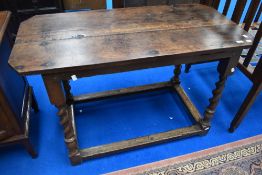 A Period oak side table in the Stuart style having canted edges on barley twist legs (been adapted