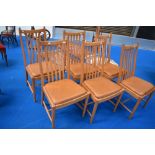 A set of six Ercol Penn classic dining chairs having upholstered leather seats and rail back,