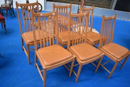 A set of six Ercol Penn classic dining chairs having upholstered leather seats and rail back,