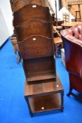 An early to mid 20th Century oak occasional twist leg table and a similar period magazine rack