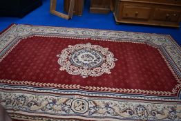A modern carpet square in shades of red and cream, approx 280 x 180cm