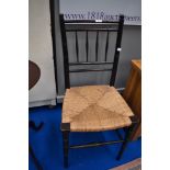 A 19th Century stained frame bedroom chair having turned frame and seagrass seat