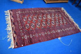 A Persian rug having red ground with shades of cream and blue, approx. 195 x 125cm