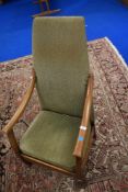 A vintage Arts and Crafts style low seat oak framed armchair having moquette style upholstery