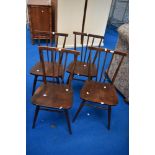 A set of four vintage Ercol spindle back kitchen chairs in dark stain