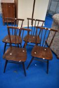 A set of four vintage Ercol spindle back kitchen chairs in dark stain