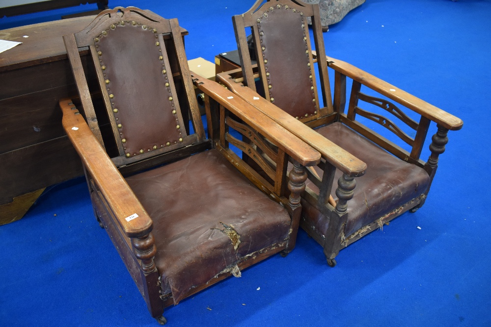 A pair of 19th Century oak reclining armchairs