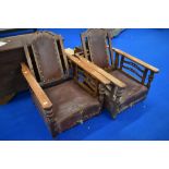 A pair of 19th Century oak reclining armchairs