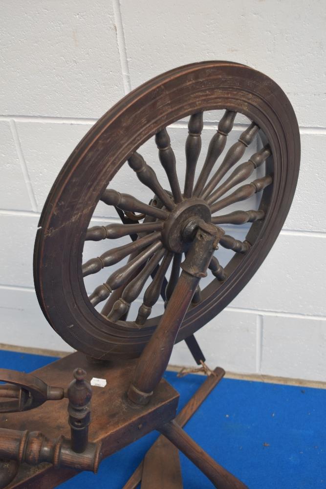 A 19th century spinning wheel, with notch carved block, turned supports and rails, the wheel with - Image 2 of 3