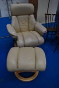 A Stressless style easy chair and footstool in cream leather
