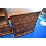 A modern Ercol mid stain bookcase TV cabinet