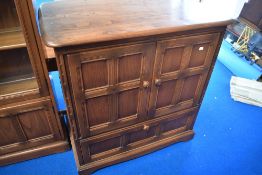 A modern Ercol mid stain bookcase TV cabinet