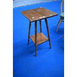 An Arts and Crafts style side table in golden oak with slight worm.