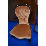 A Victorian mahogany framed nursing chair having later button back upholstery