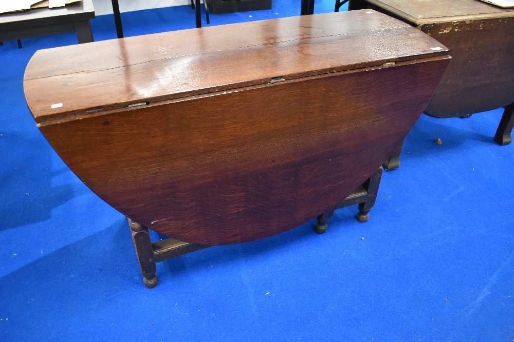 A period oak gateleg dining table having frieze drawer and turned frame