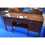 A late 19th or early 20th Century mahogany sideboard having central drawer and shelf, flanked by