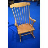 A traditional beech framed rocking chair