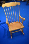 A traditional beech framed rocking chair