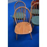 A set of four Ercol hoop and stick back chairs, with seat cushions and H stretchers, in light stain