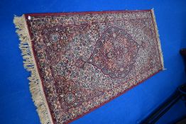 A vintage fireside rug, having red ground and multi pattern, approx. 180 x 90cm