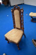 A 19th Century mahogany hall chair having mahogany twist and scroll frame with upholstered back