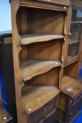 A modern Ercol mid corner shelf with cupboard under