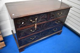 A 19th Century mahogany chest of two over two drawers, having carved foliate scroll decoration and