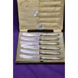 A cased set of six silver plated butter knives