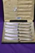 A cased set of six silver plated butter knives