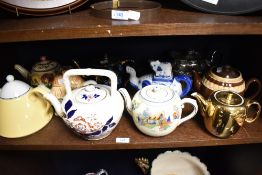 An assorted collection of teapots, of different designs and ages, to include a cottage ware